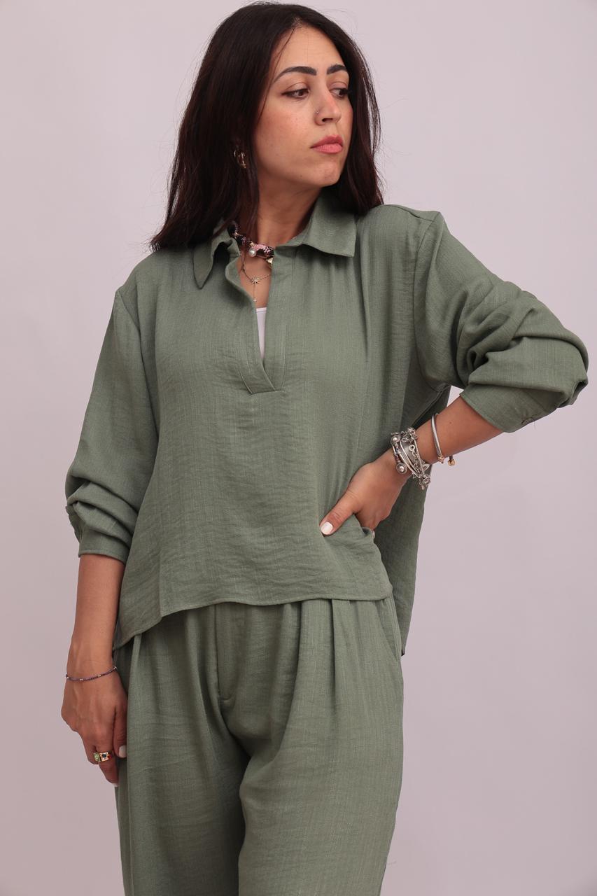 Full-body shot of a model styling a sage green linen pullover collar shirt and matching wide-leg trousers.